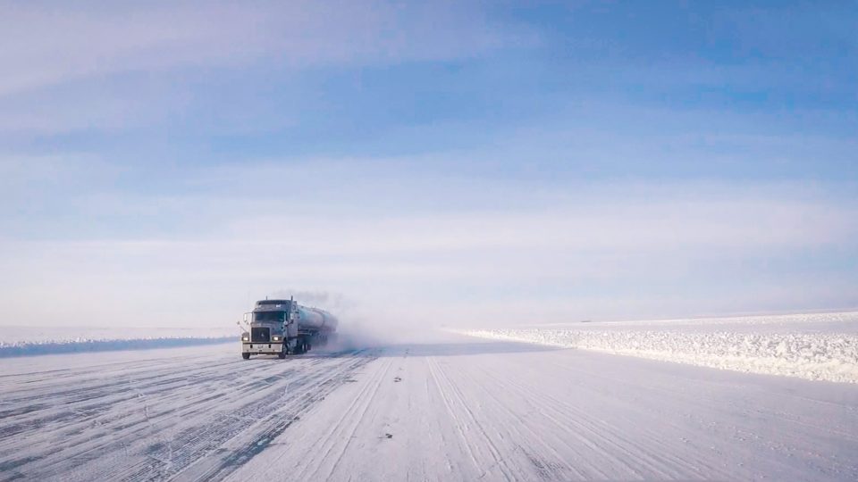 A view of a truck making its way along the winter ice road through the Slave Geological Province