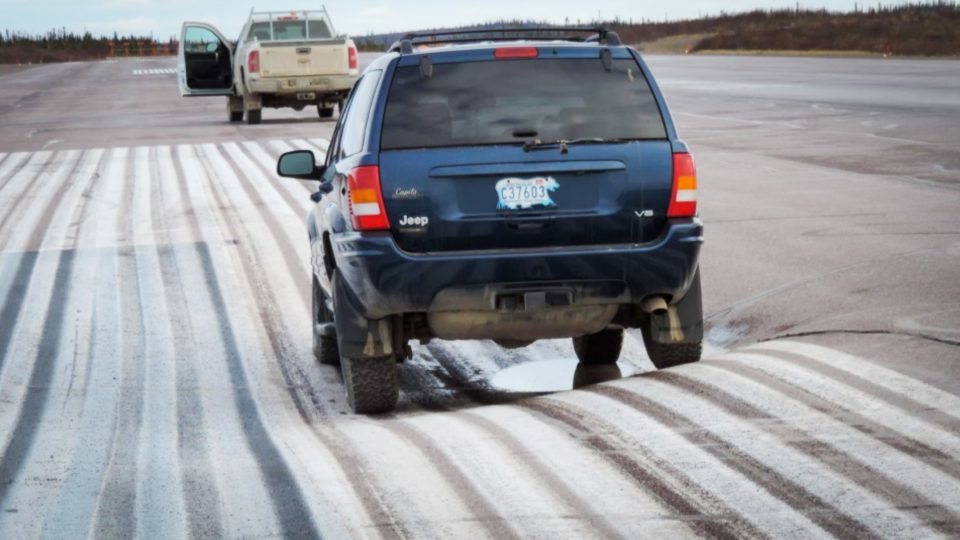A 2013 territorial government image shows an SUV resting in a permafrost-related depression at Inuvik Airport