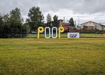 A sign reading 'Poop' dominates the neighbourhood of a Yellowknife ballpark