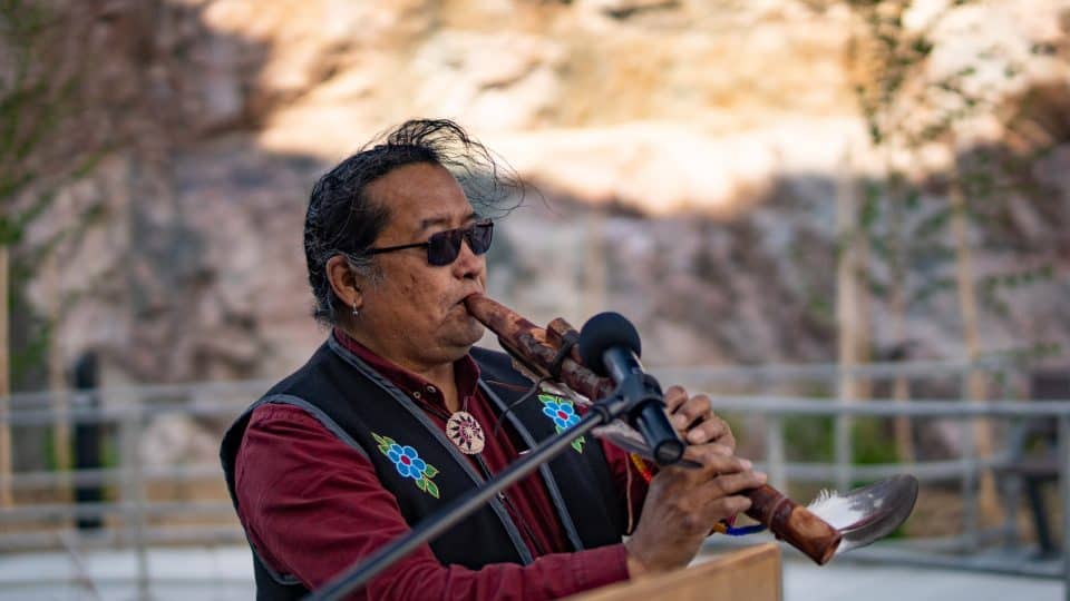 William Greenland plays a flute song at the grand opening of the Stanton Territorial Hospital in July 2019. Sarah Pruys/Cabin Radio