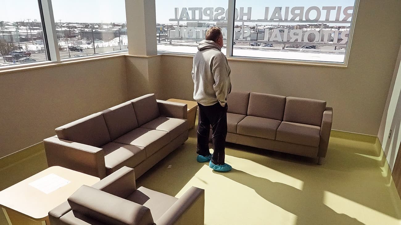 A resident stands inside the second-floor lounge of the new Stanton Territorial Hospital in April 2019