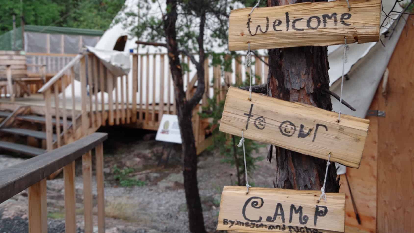 A handmade sign welcomes people to Yellowknife's Arctic Indigenous Wellness Foundation's healing camp