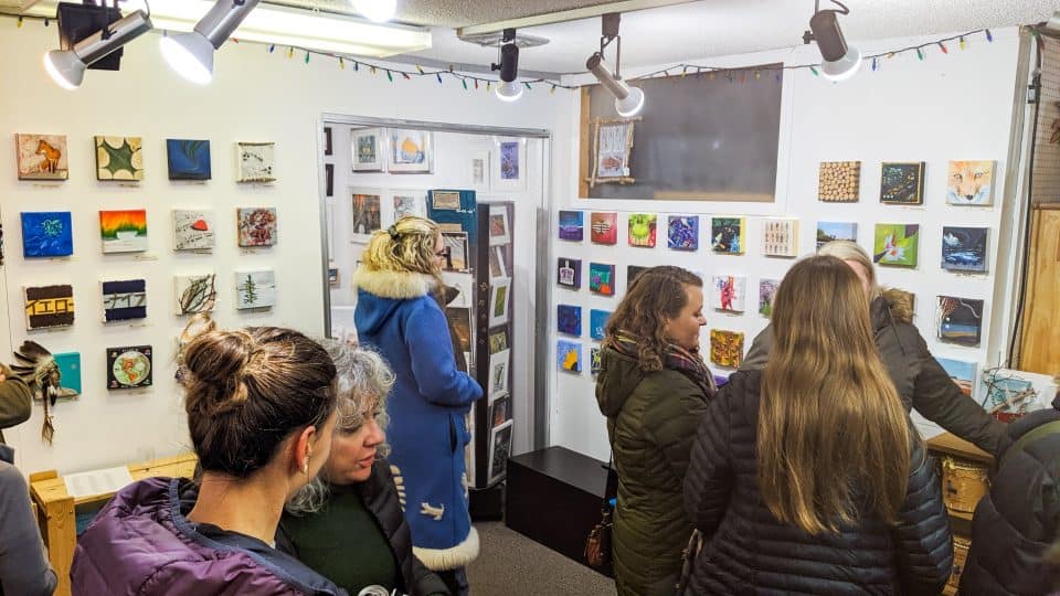 Yellowknife residents admire anonymous works of art inside the Down to Earth Gallery