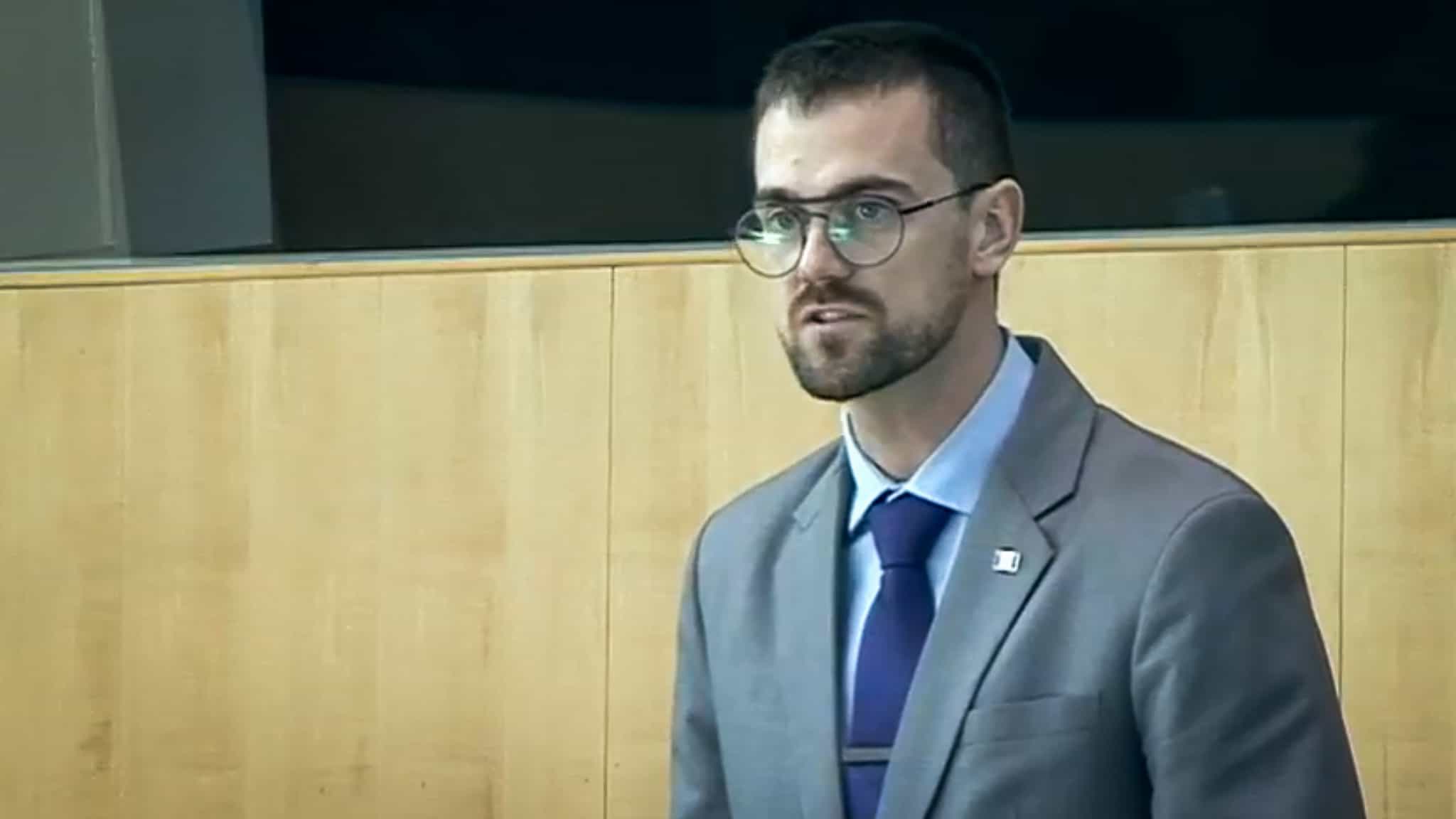 Rylund Johnson addresses the legislature in October 2019