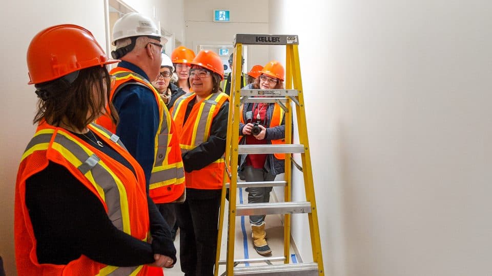 Paulie Chinna, the housing minister (centre), talks to NWT Housing Corporation boss Tom Williams as they tour the Yellowknife's women's emergency shelter