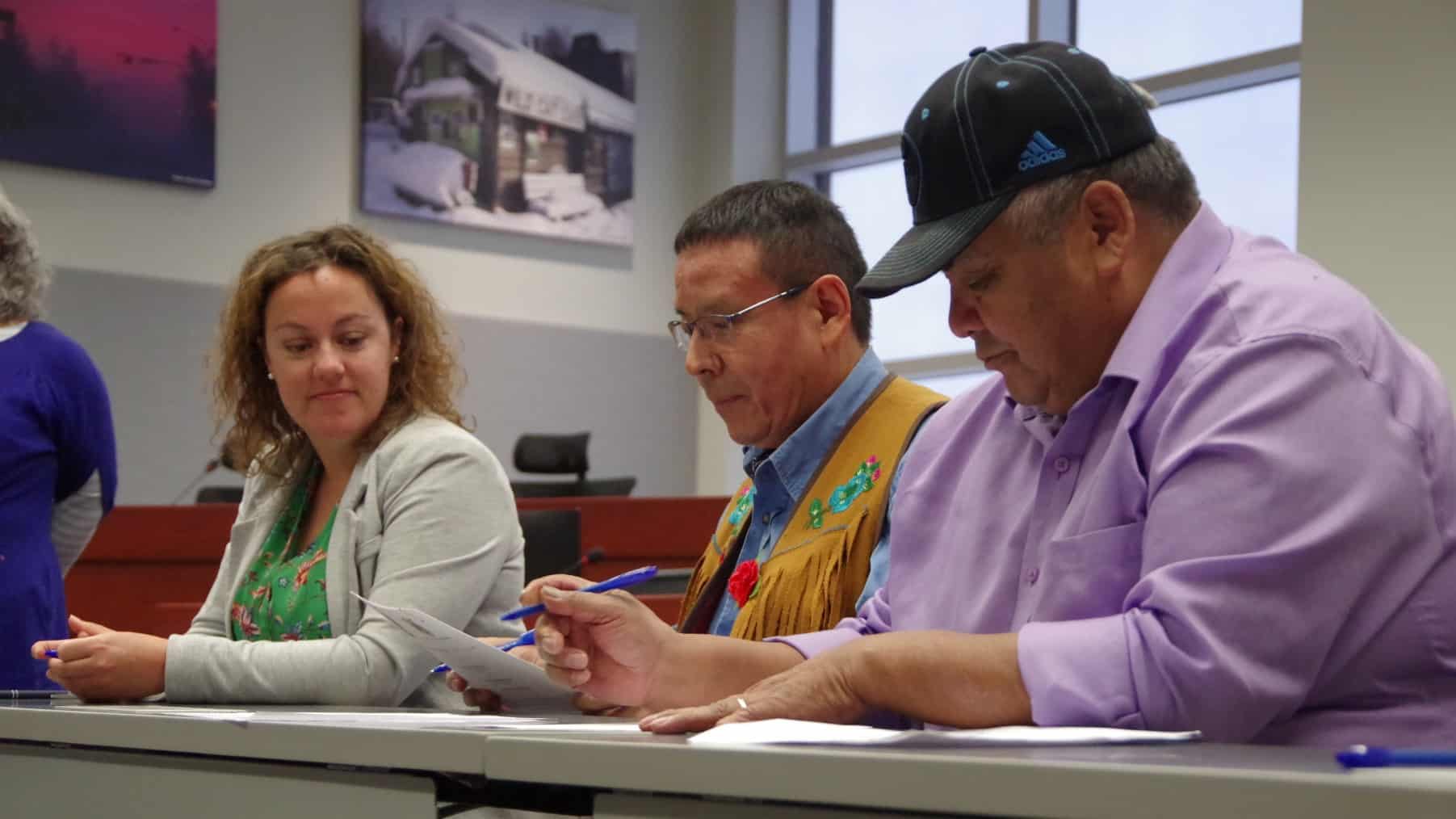Mayor Rebecca Alty, left, with Yellowknives Dene chiefs Ernest Betsina, middle, and Edward Sangris at the signing
