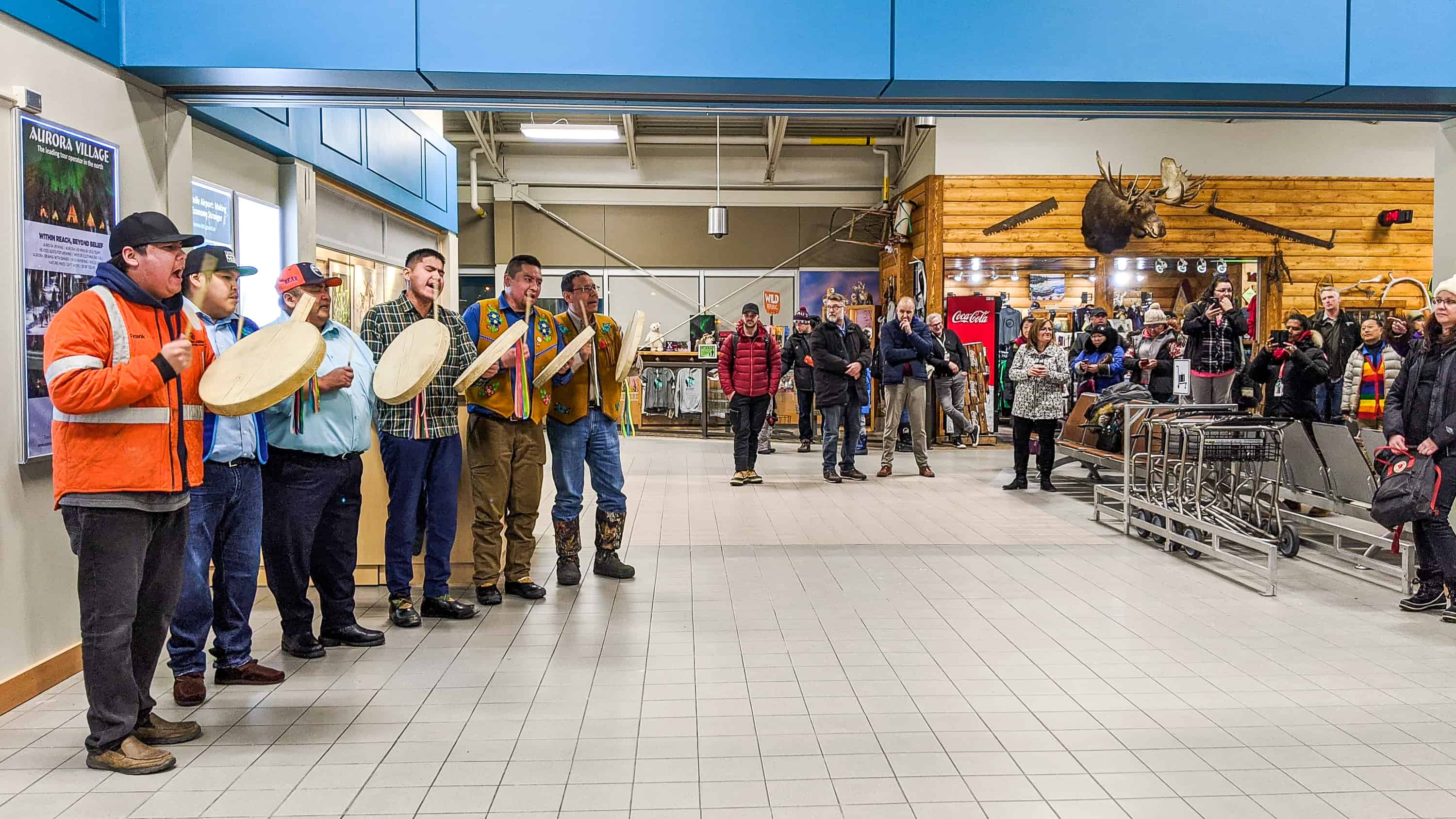 Dene drummers welcome passengers from Vancouver arriving at Yellowknife Airport