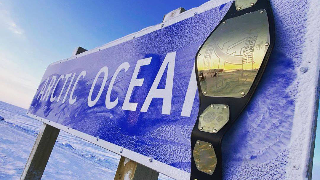 A photo supplied by Totally Arctic Wrestling shows a belt atop an Arctic Ocean sign