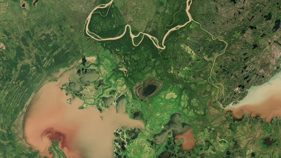 A satellite image shows Lake Claire, a portion of Lake Athabasca, and a portion of the Peace River
