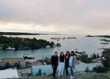 L-R: Christina Moore, Kalina Newmark, Xina Cowan, and Mahalia Yakeleya-Newmark from the Strong People, Strong Communities mural project on top of Yellowknife's Pilots' monument