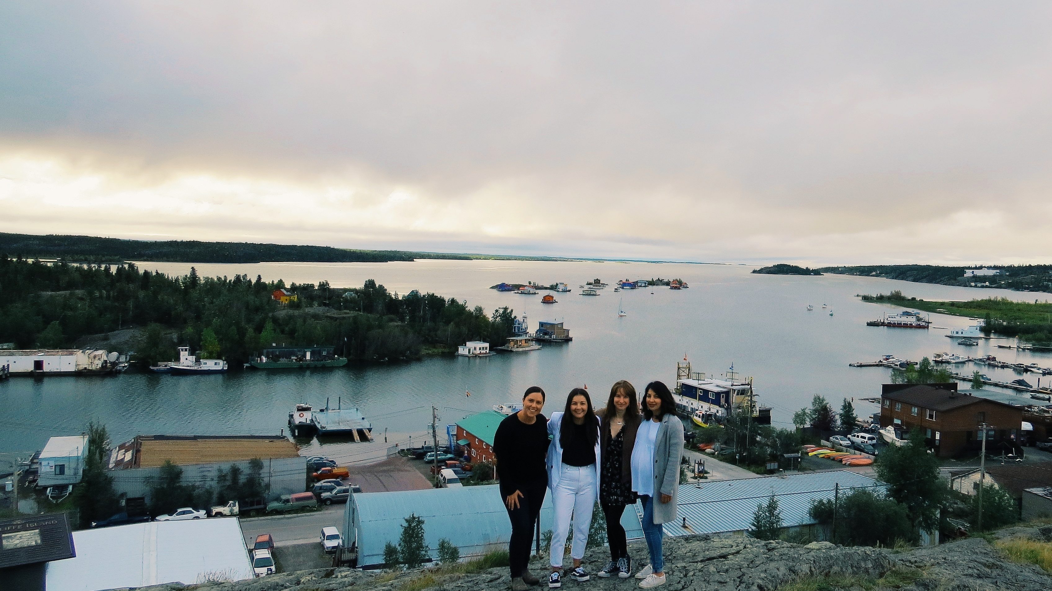 L-R: Christina Moore, Kalina Newmark, Xina Cowan, and Mahalia Yakeleya-Newmark from the Strong People, Strong Communities mural project on top of Yellowknife's Pilots' monument