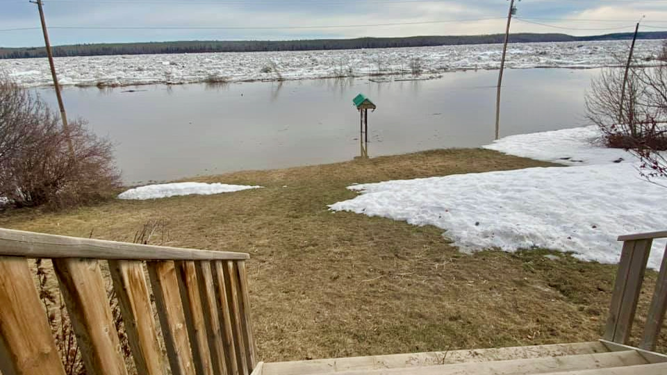 Water covers the road in Fort Simpson on Saturday morning
