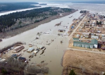 Floodwater covers a runway next to the village of Fort Simpson on May 9, 2021