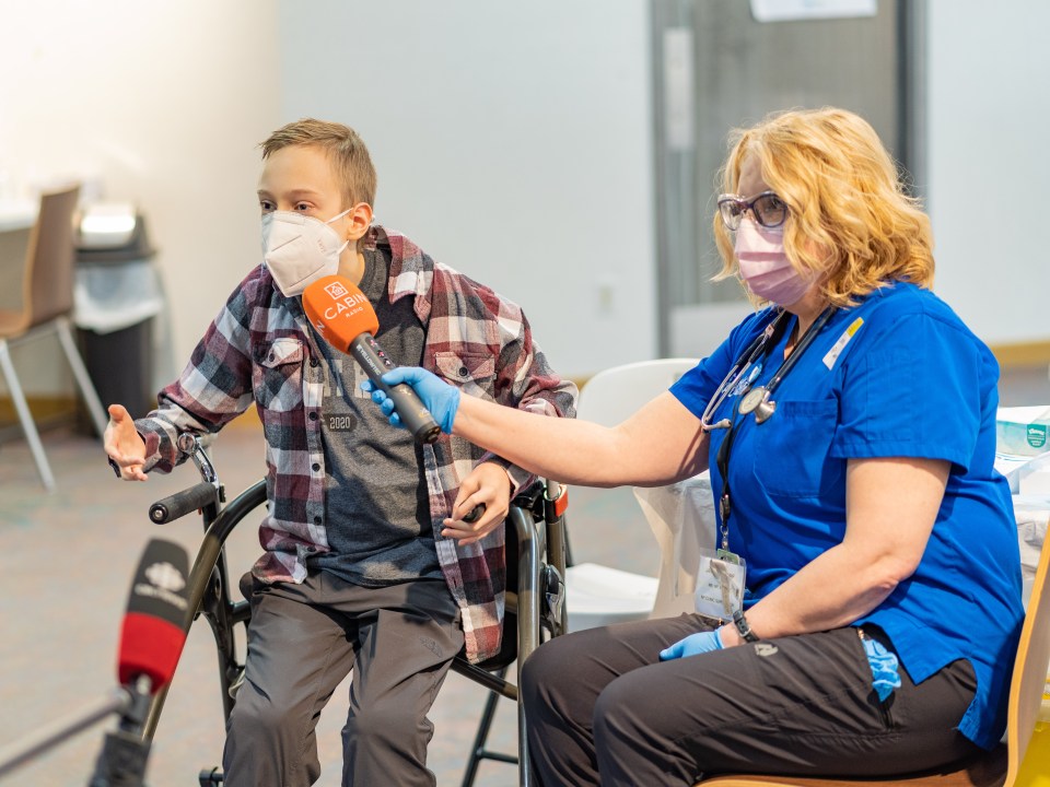 Riley Oldford, left, talks to reporters after becoming the first Yellowknife teenager to receive the Pfizer-BioNTech vaccine on May 6, 2021