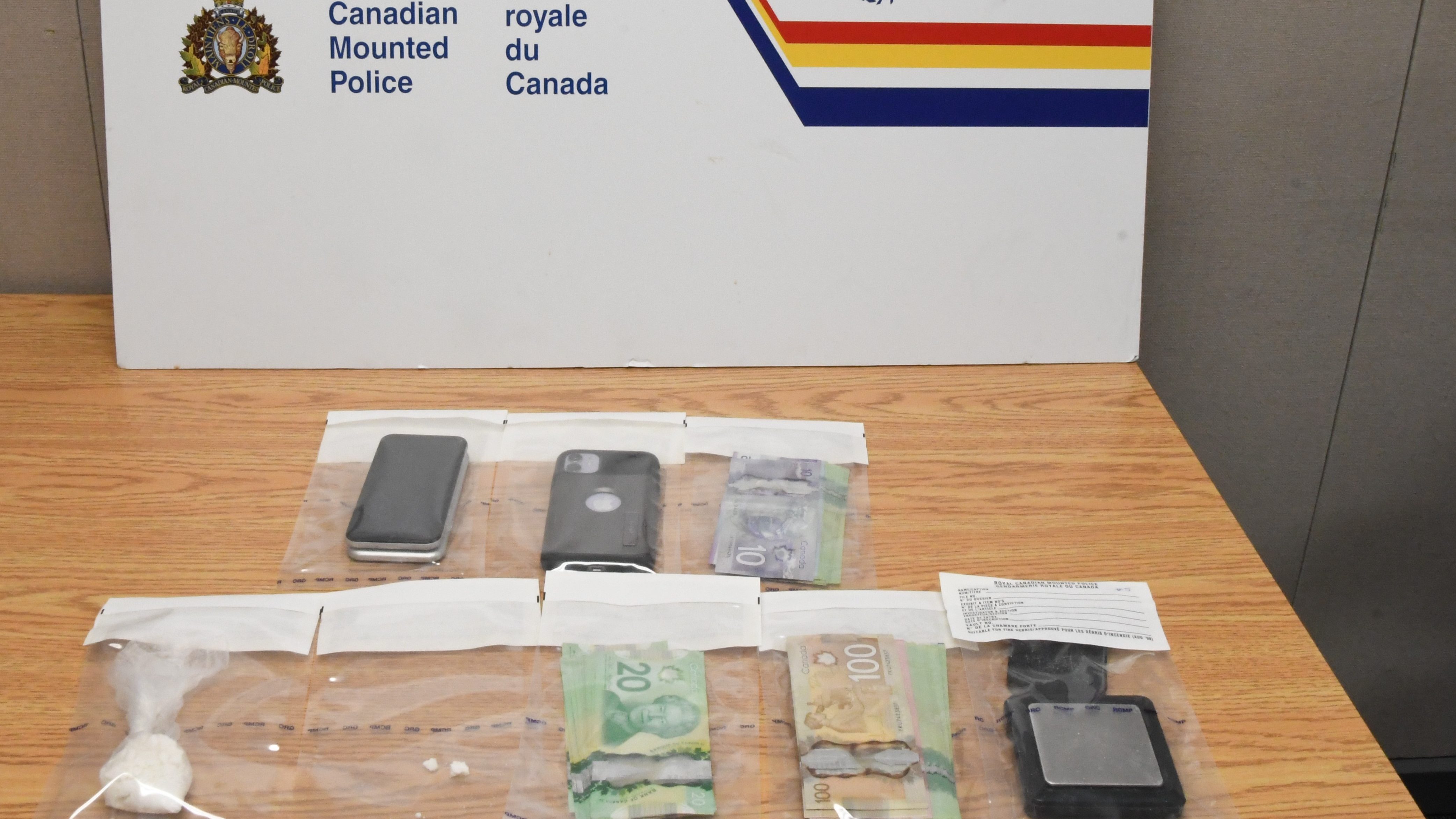 An RCMP photo of the drugs, cash, and cell phones siezed during an arrest on August 18, 2021 in Yellowknife.