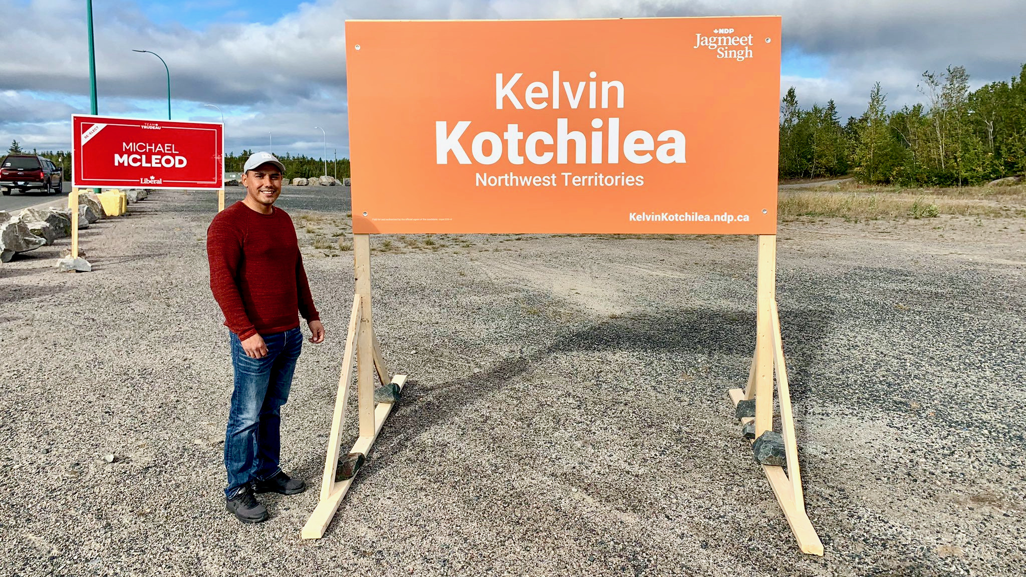 Kelvin Kotchilea stands beside election signs in early September 2021