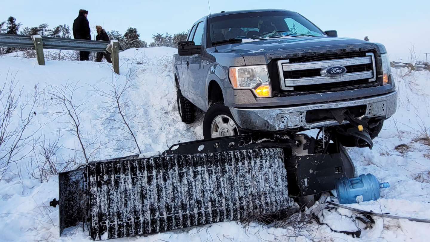 Richard Beck's snowmobile beneath a truck following a collision on December 13, 2021