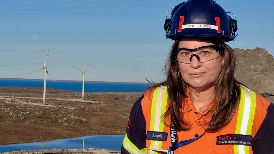 Angela Bigg in front of Diavik's wind farm