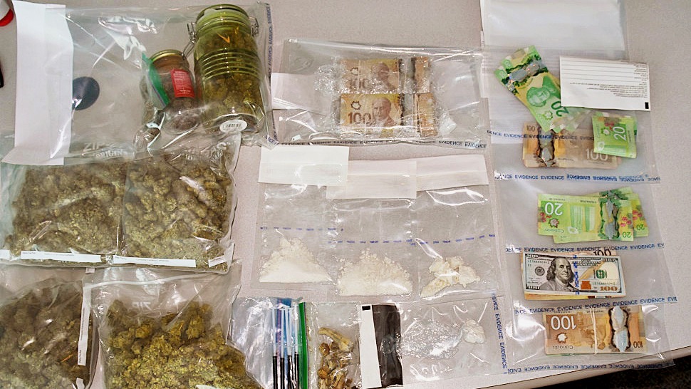 An RCMP handout image of drugs and cash seized in a suspected trafficker’s SUV, clothing and Yellowknife home in April 2020