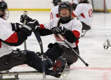 Athletes celebrate a goal during a game between two teams of para hockey players trying out for the national team