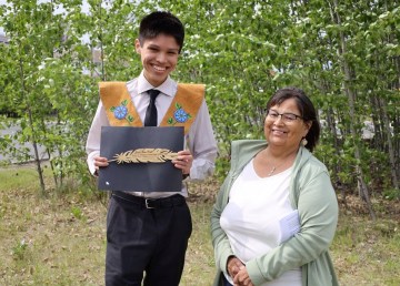 Jaylen Base-Smith accepts one of the inaugural Sacred Feather Indigenous Student Awards from YK1. Credit: Yellowknife Education District No. 1