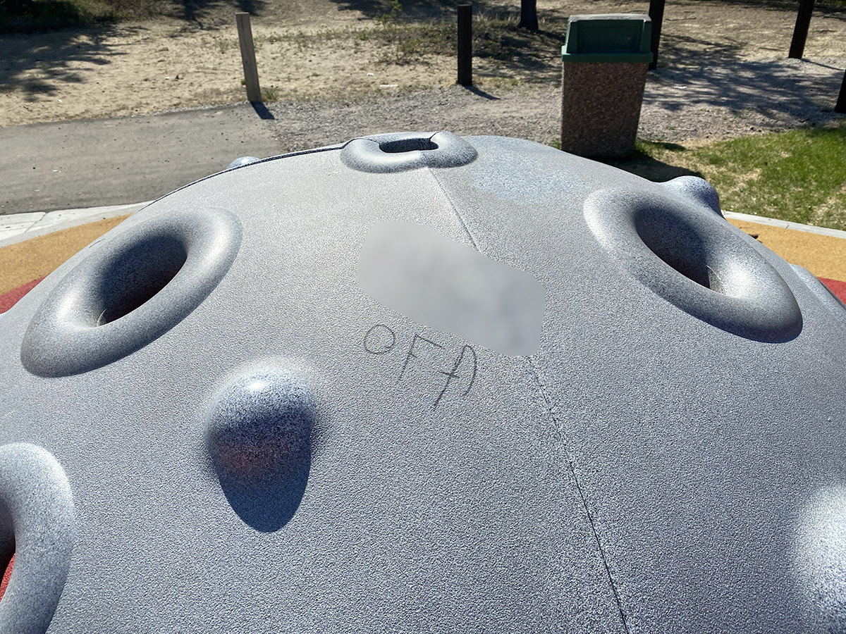 A photo of graffiti on the accessible playground in Yellowknife's Somba K'e Park on June 8, 2022.
