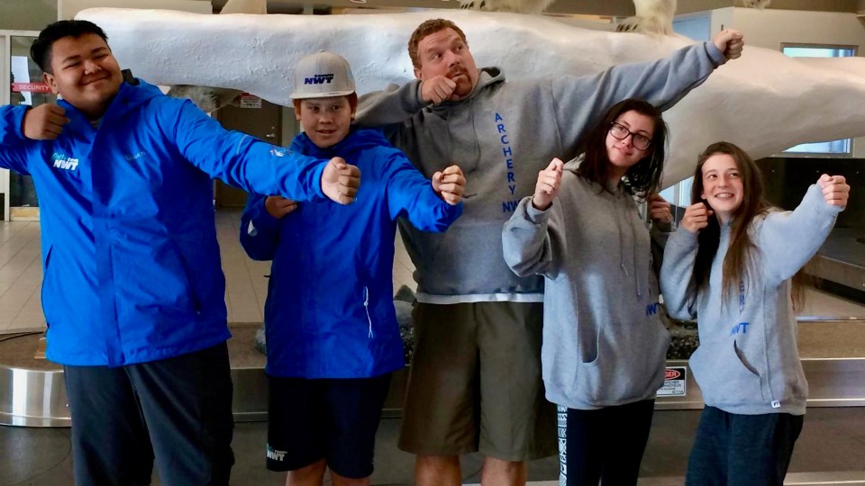 Eugène Roach, centre, with members of the NWT Canada Games archery team he coached