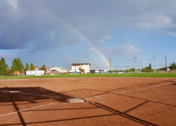 A rainbow appears over a Yellowknife slo-pitch diamond in a photo shared to the slo-pitch association's Facebook group by Rebekah Clarke