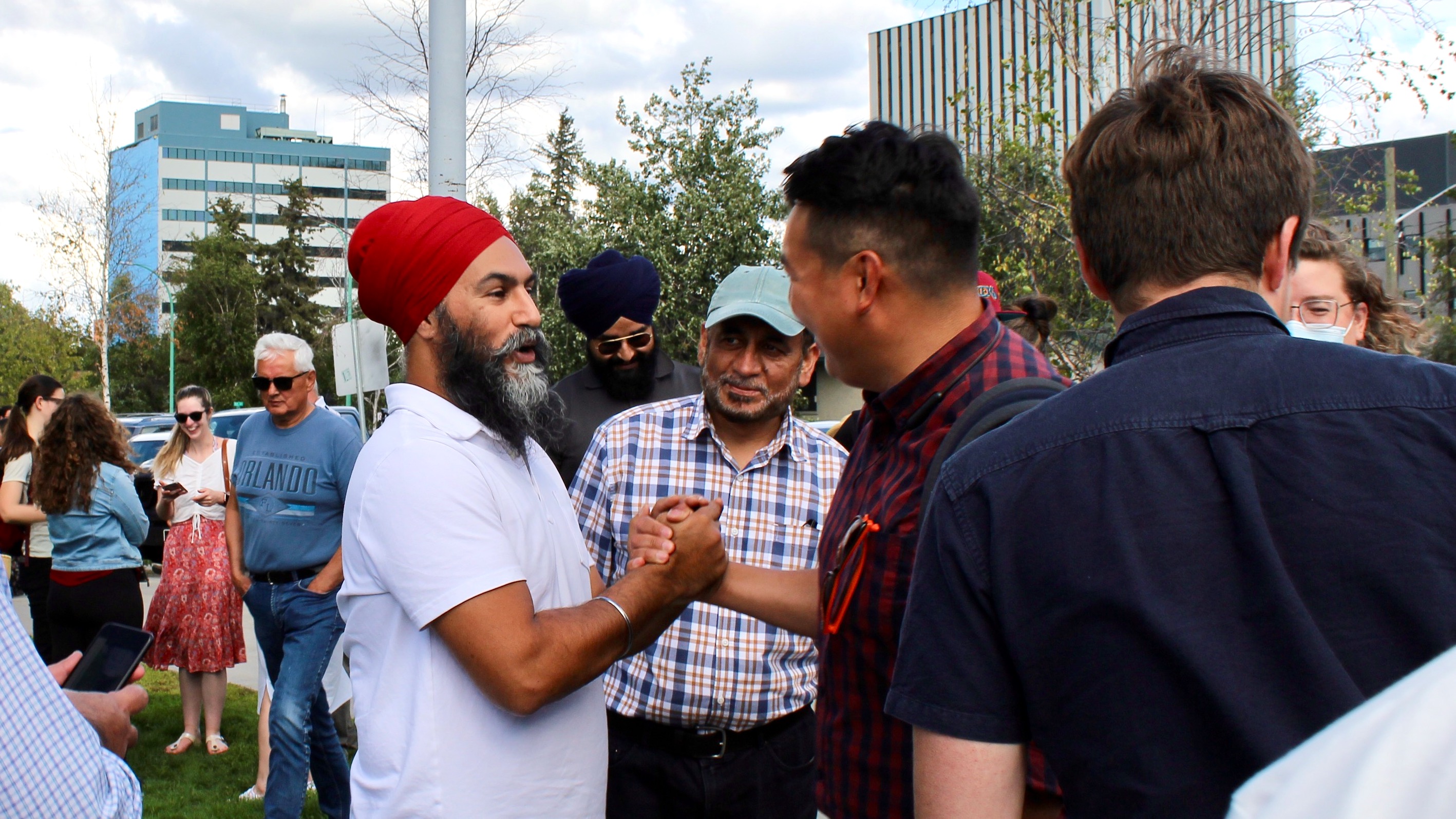 Jagmeet SIngh, left, meets Yellowknife residents at the city's farmers' market on July 19, 2022