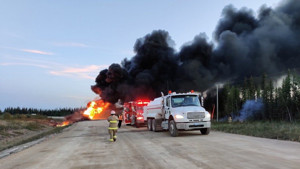 Firefighters work on a vehicle fire south of Fort Providence on July 26, 2022
