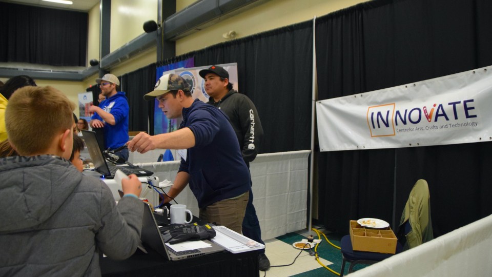 Brian Larman and Justin Pascal of the Innovate Centre print free mugs for trade show attendees