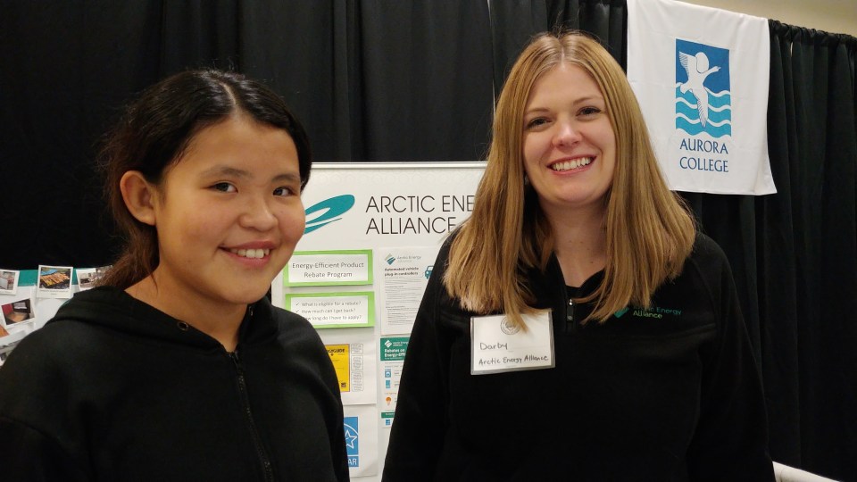 Jocelyn Jerome and Darby Desrosiers at the Arctic Energy Alliance booth