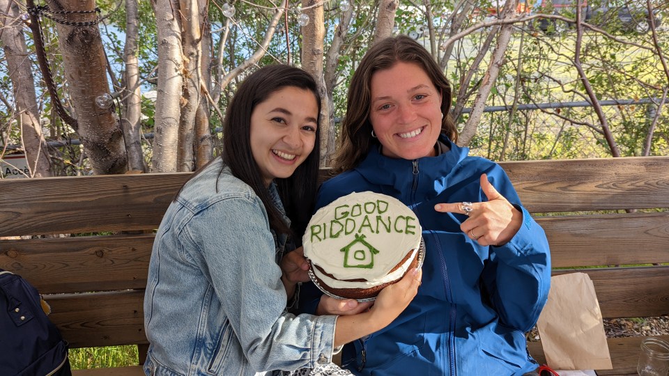Cabin Radio 2022 summer interns Amelia Eqbal, left, and Sophie Kuijper Dickson share a touching gift from the newsroom on their last day