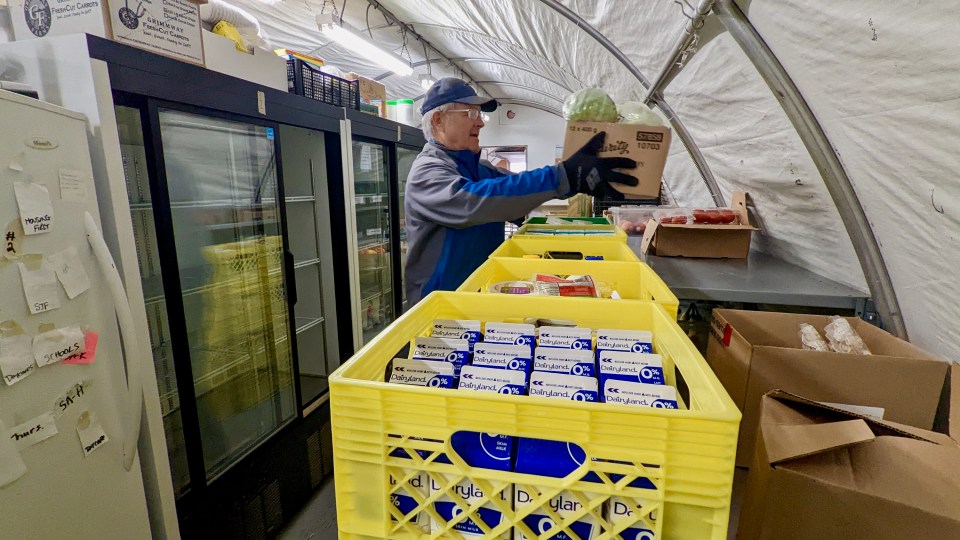 Crates of unsold food from grocery stores arrive at Food Rescue