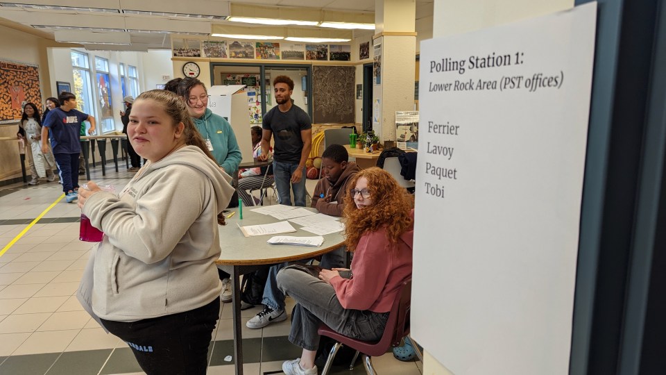 Gracie Brennan, front right, and Taylor Foss, front left, await voters