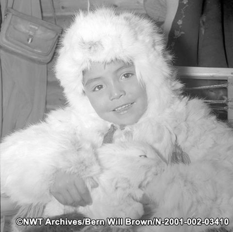 Kenneth Turo at Christmas 1968, wearing a traditional hareskin parka while holding a snowshoe rabbit
