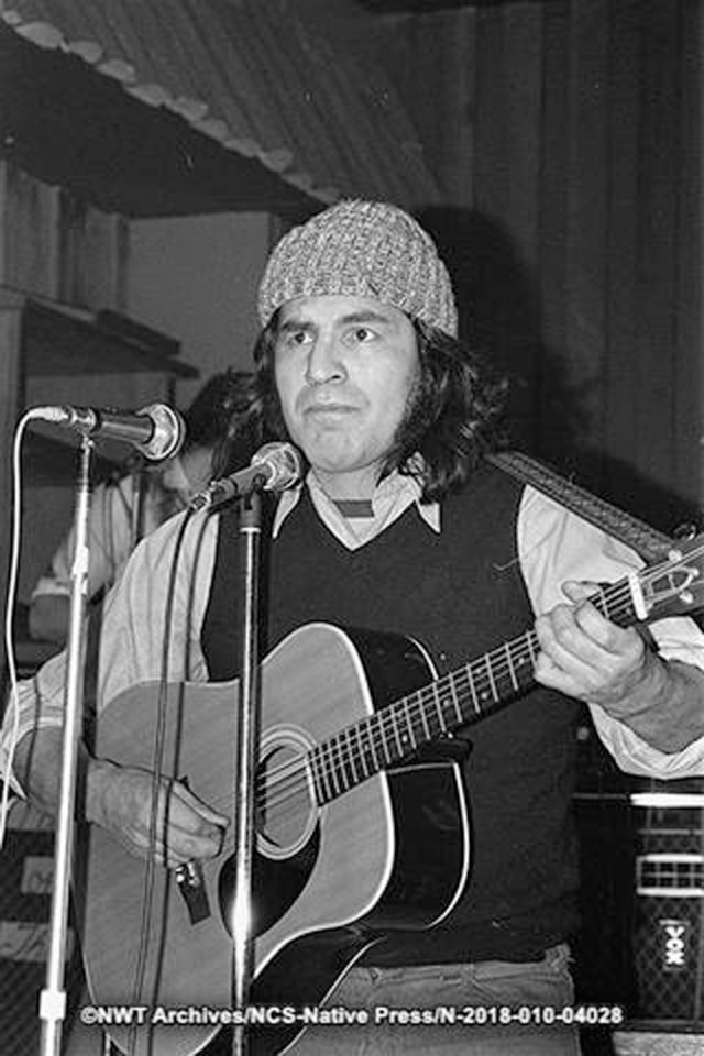 Herbie Beaulieu playing guitar at the seventh annual Christmas Daddy Show at the Elks Hall in Yellowknife. NWT Archives/Native Communications Society fonds - Native Press photograph collection