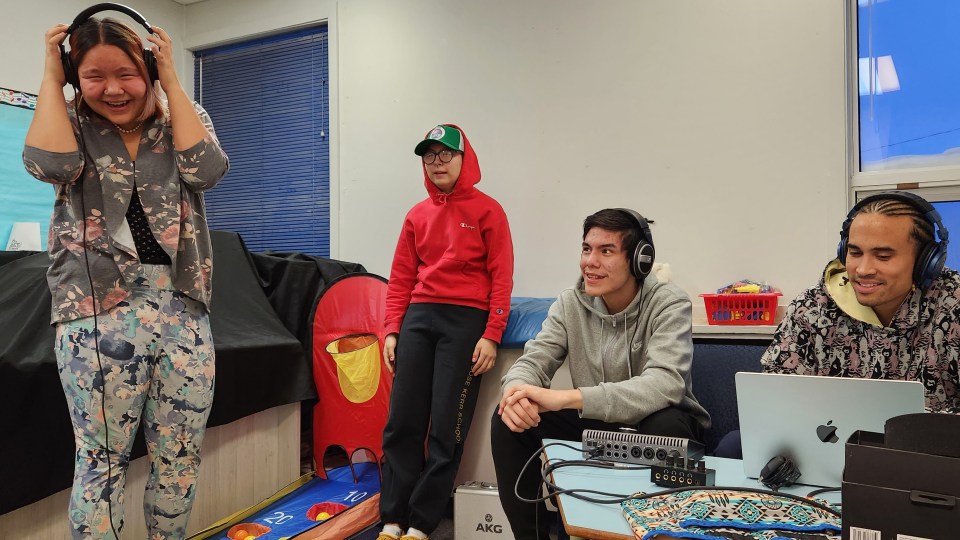 Aklavik students Destiny Benoit and Deena Benoit recording with N'we Jinan members Derwin Watt, a 17-year-old God's Lake Narrows, Manitoba rapper, and Milan Andre