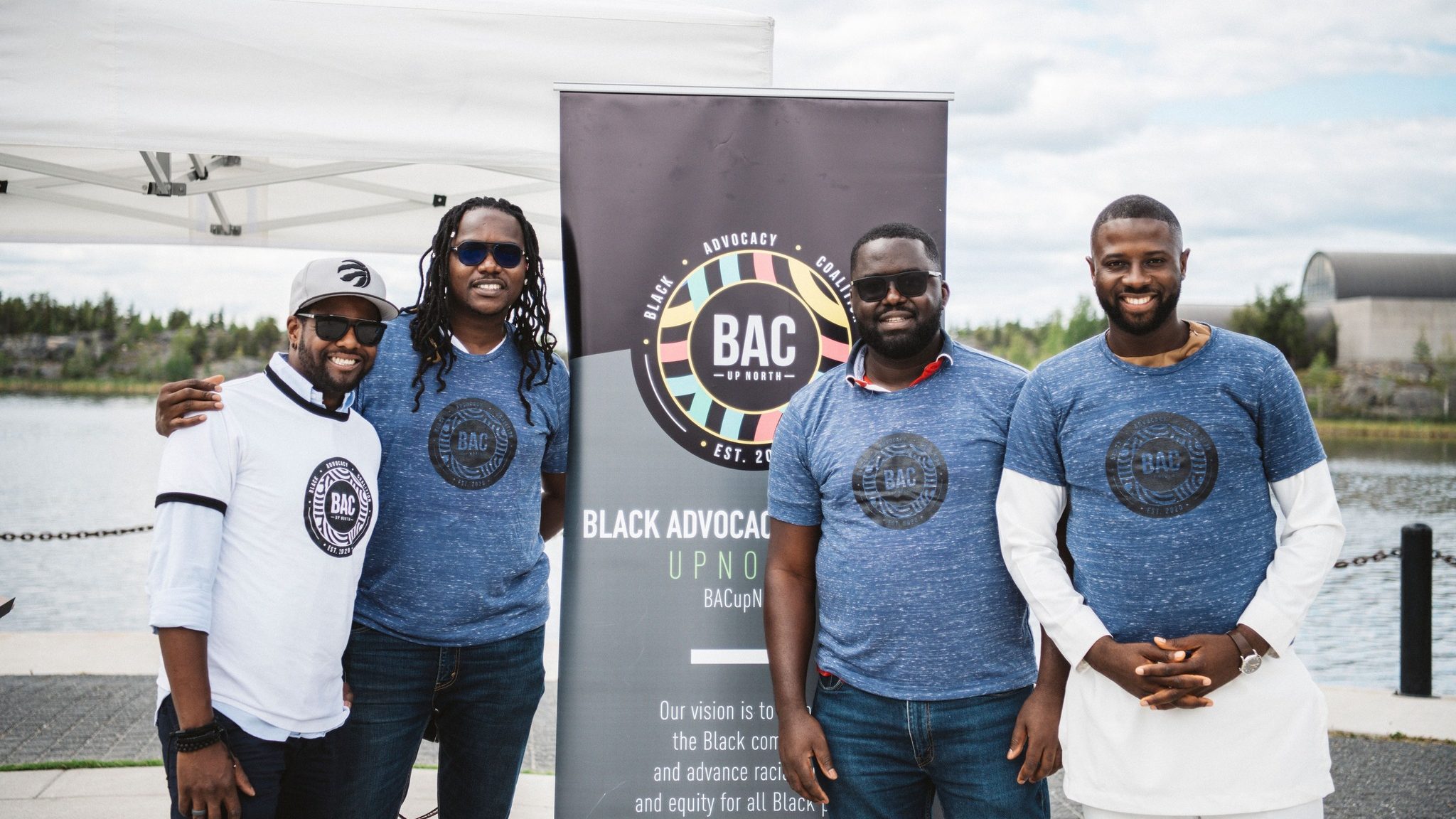 Ambe Chenemu, right, with members of the Black Advocacy Coalition in a photo posted to Facebook after the coalition's Emancipation Day event in August 2022.