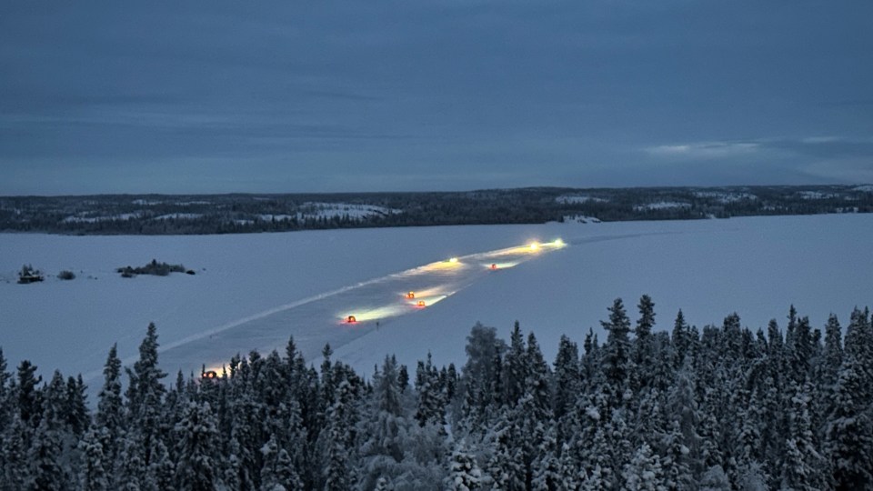 Cars on the Dettah Ice Road with cloudy skies on the morning of January 11, 2023