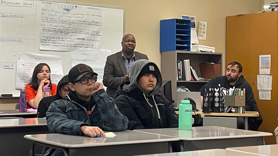 Moses Garaba, principal of East Three Secondary School, asks a question of Dallaire