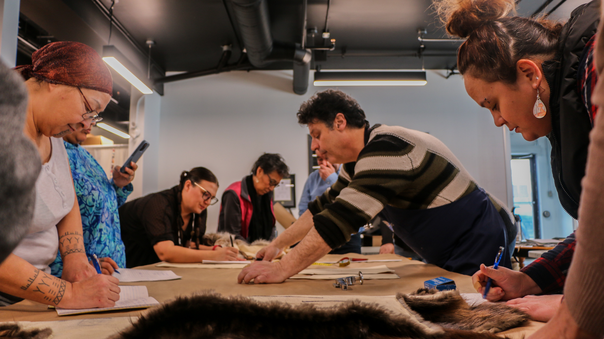 Master furrier Panos Panagiotidis teaches participants at a Yellowknife sealskin workshop