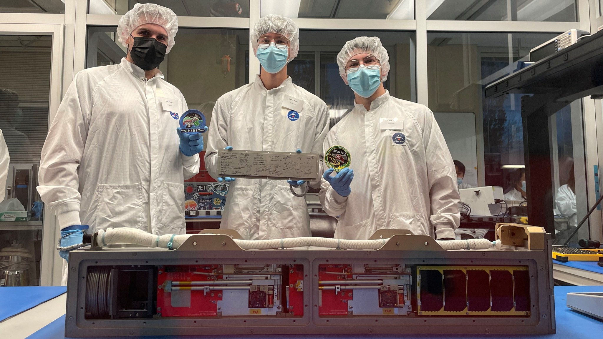 Patrick Gall, left, with Thomas Ganley and Josh Lazaruk and their CubeSats: AuroraSat, YukonSat and Neodose