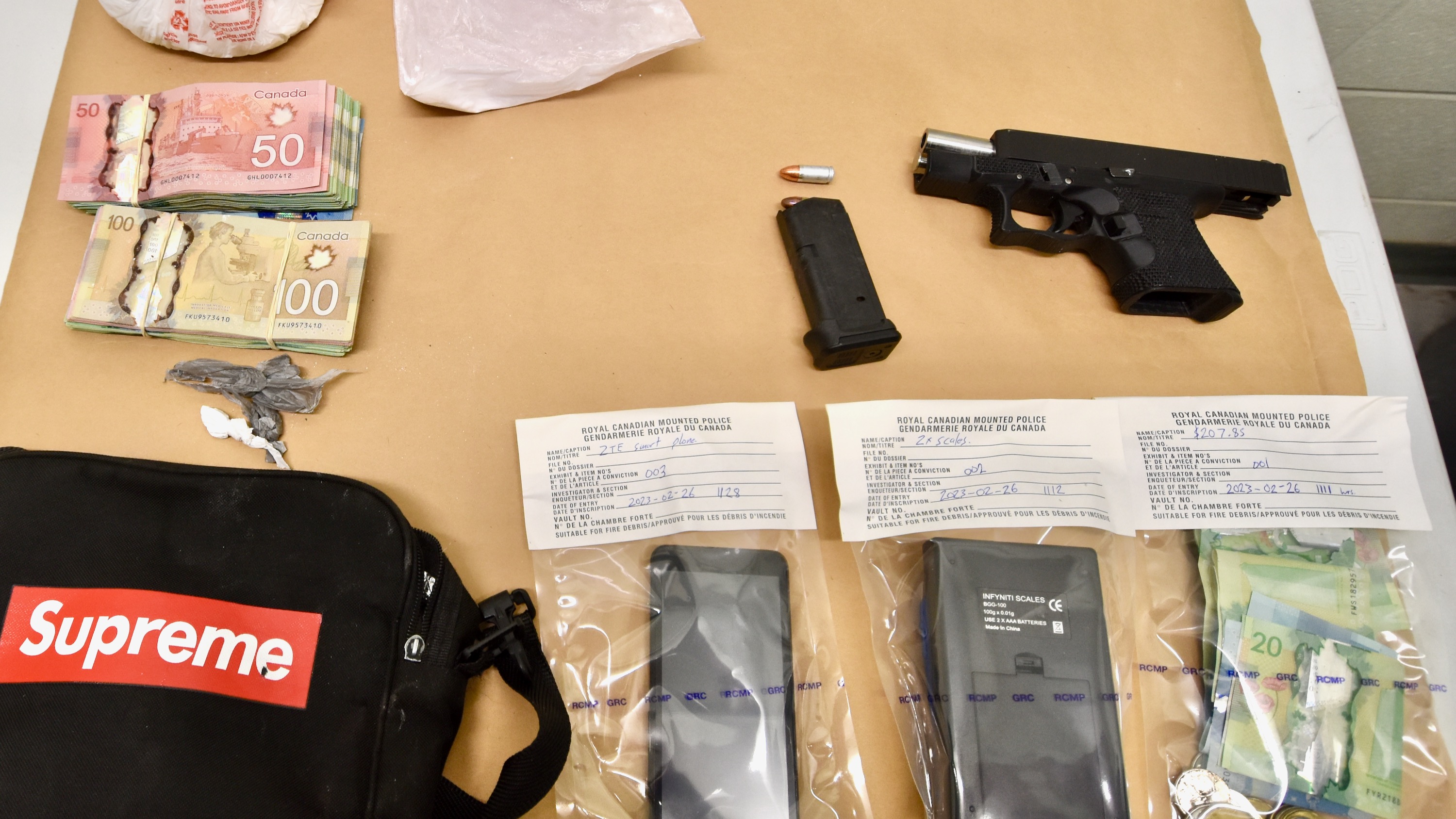An RCMP handout image of a gun said to have 3D-printed parts alongside other items police say were seized from a Yellowknife home