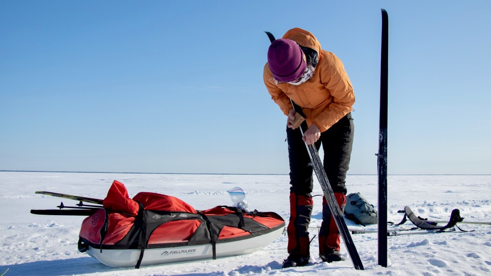 Sara Wong waxes a ski