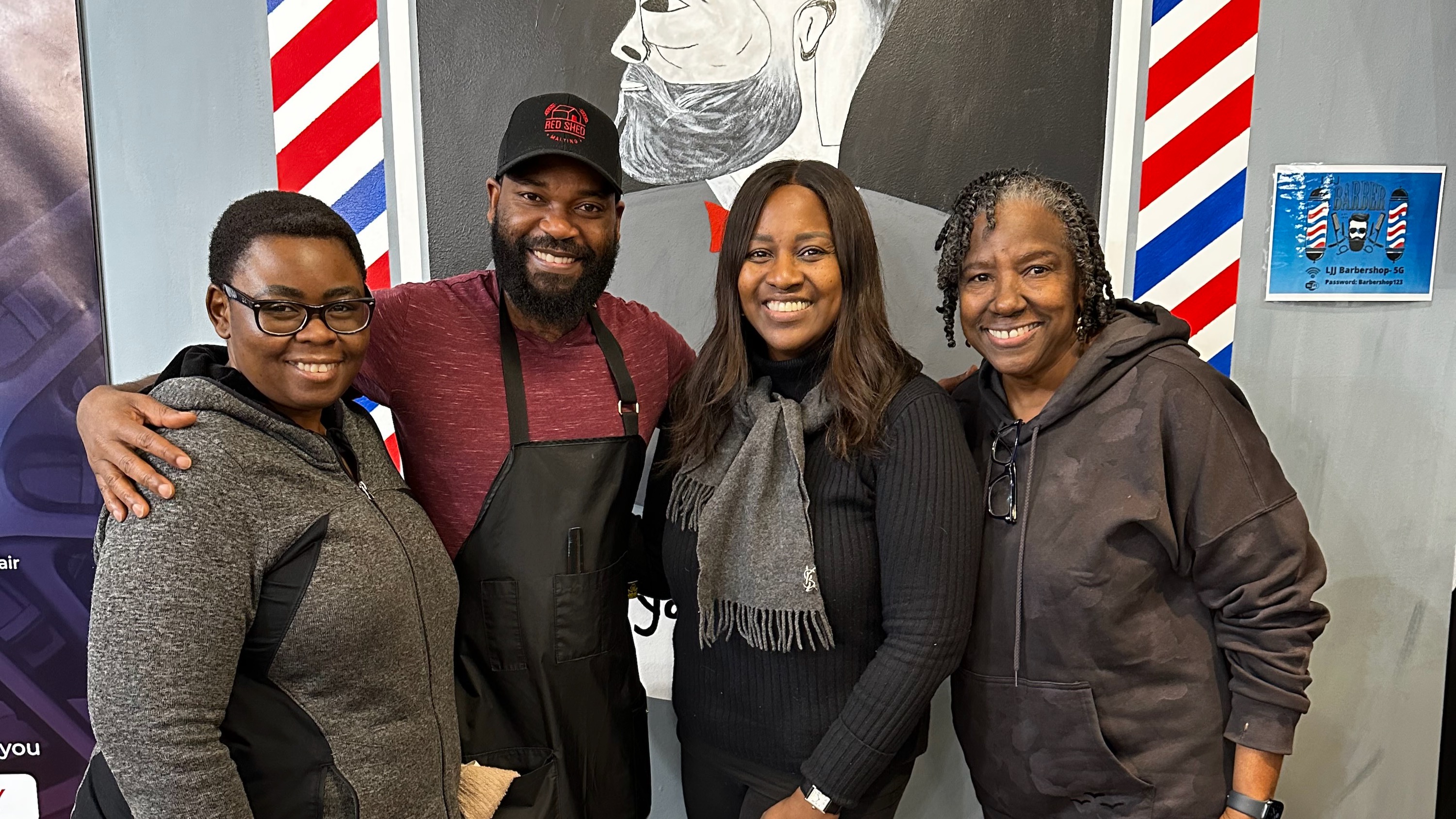 The BBPA's Frances Delsol, right, visits Yellowknife's LJJ Barber Shop