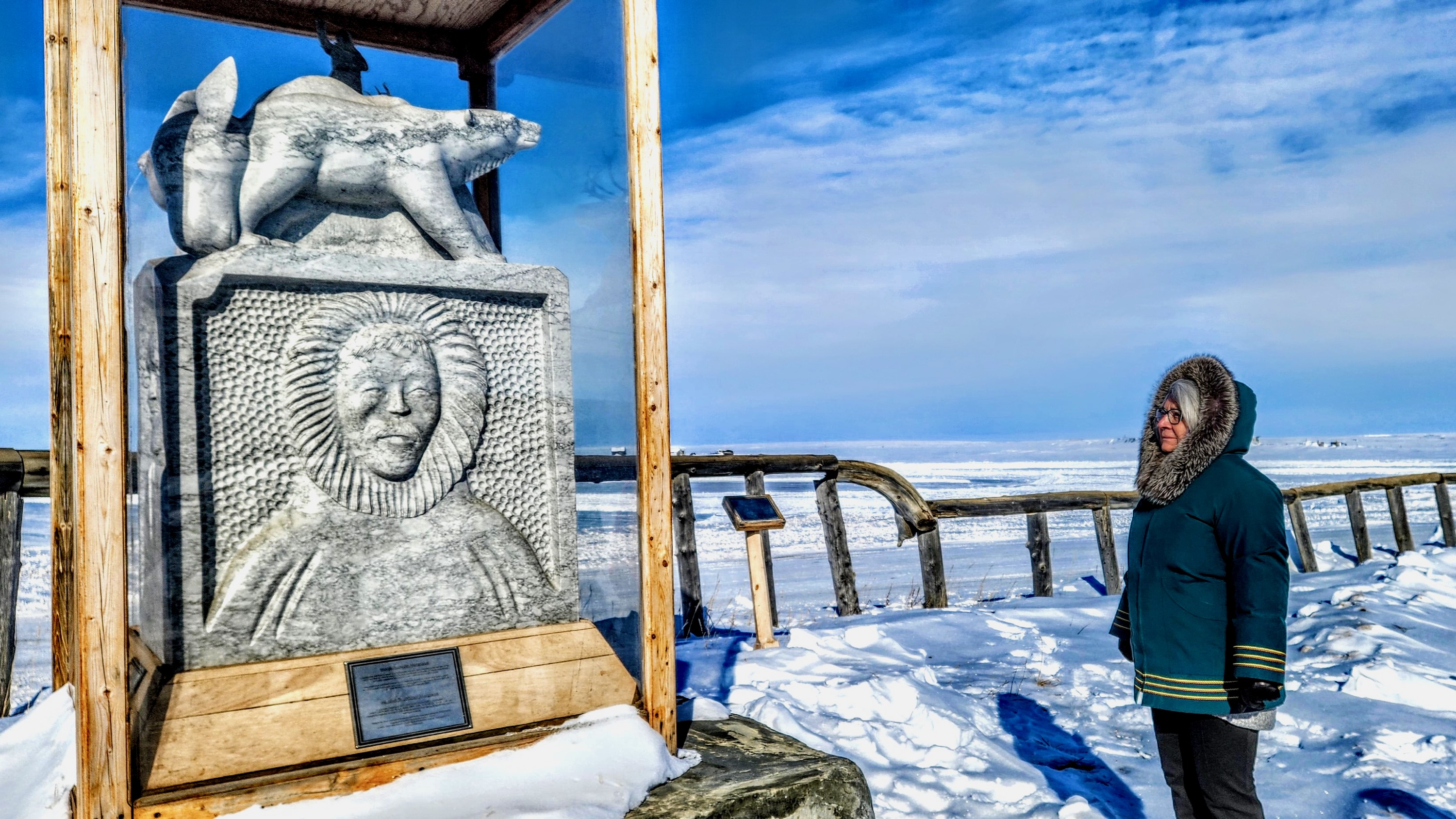 Governor General Mary Simon inspects a cultural sculpture in Tuktoyaktuk