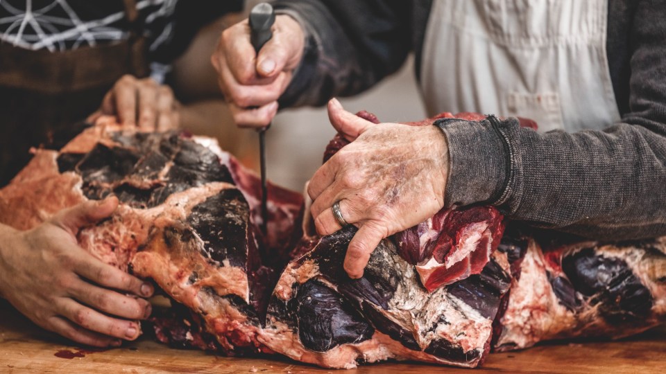 Duane Bohlken and Jaryd McDonald cut up a muskox. Josh Ferguson/Norteno Media