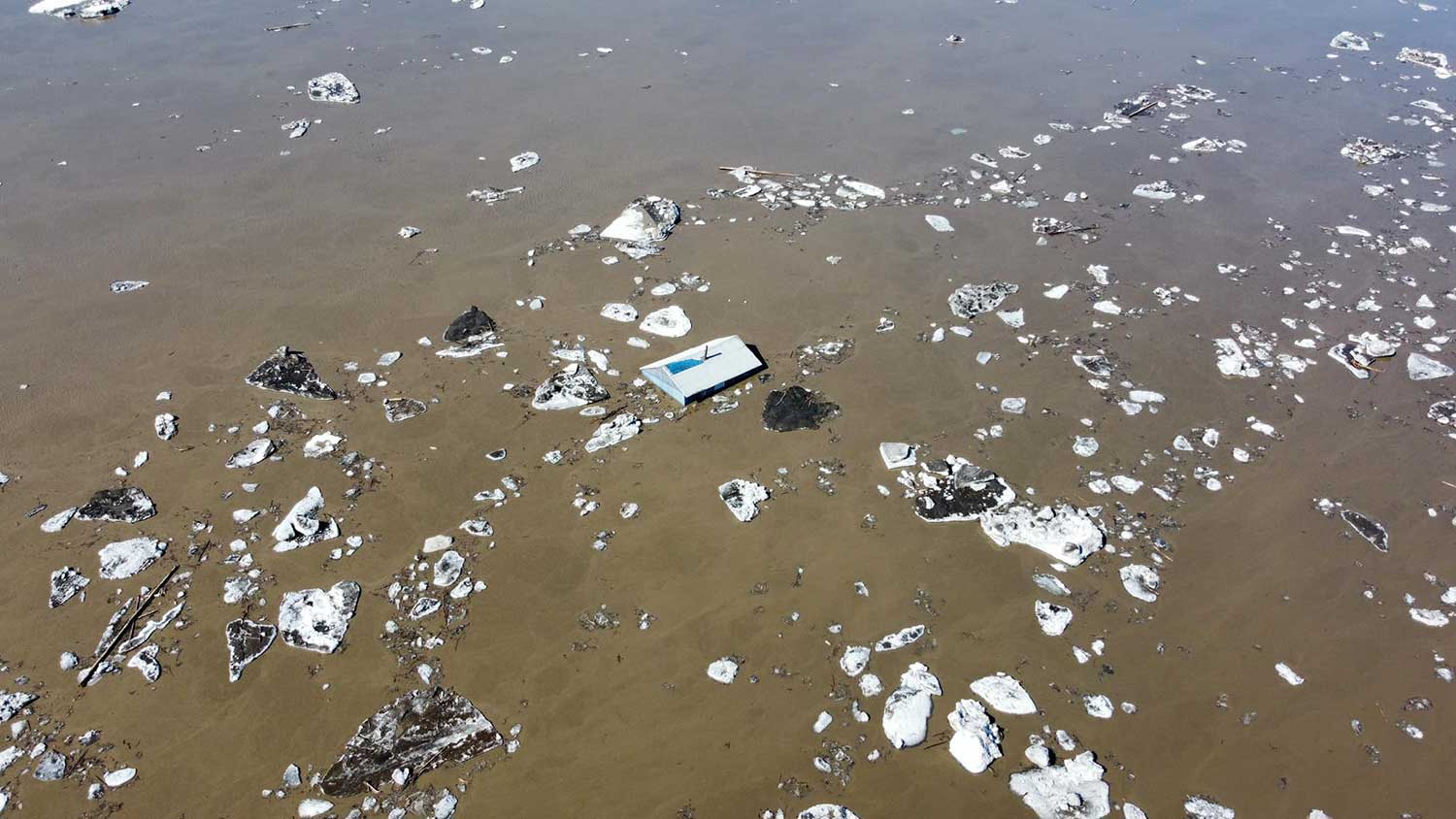 A cabin floating in the Peel River at 8 Mile, south of Fort McPherson, on May 17, 2023