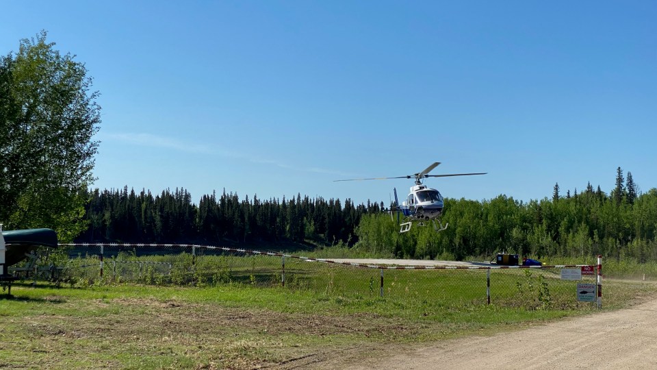 A helicopter prepares to help tackle the Hay River-KFN fire